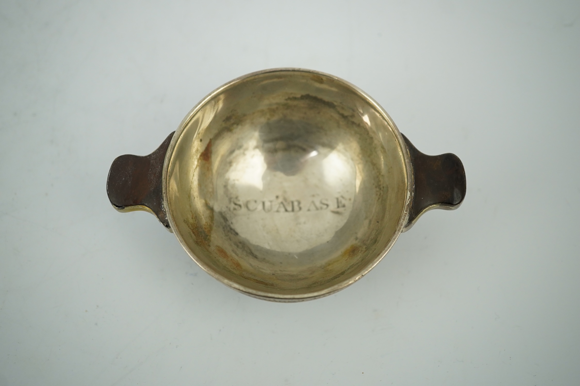 An early 19th century silver mounted yew wood quaich, inscribed 'Scuab As E' to the bowl and 'To Charles Gibson / From A Butter of Faskally' around the rim, dated 1830 beneath one handle, 10.6cm over handles. Condition -